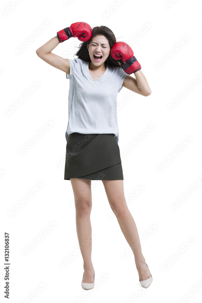 Young woman shouting with boxing gloves Young woman shouting with boxing gloves