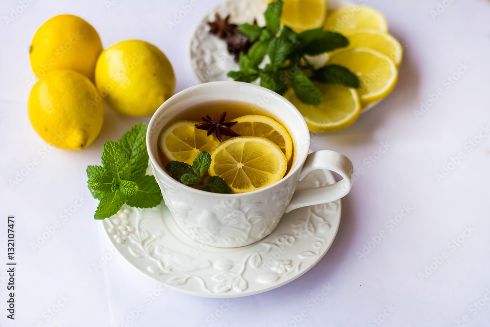 tea with lemon, honey, mint and spices on a white background tea with lemon, honey, mint and spices on a white background