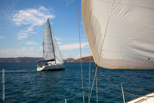 Boat competitor of sailing regatta in clear weather. Luxury yachts.