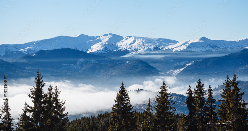 Winter mountains covered with fog