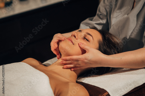 the woman doing the facial massage