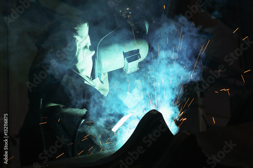 Welder of Metal Welding with sparks and smoke