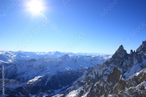 Alps in winter sunny day. Mont Blanc region with Courmayeur ski resort.