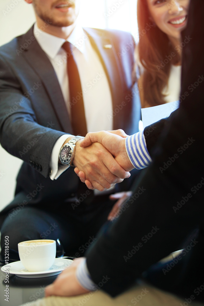 Business people shaking hands, finishing up a meeting. Business people shaking hands, finishing up a meeting.