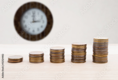 Business growth chart from coins finance and concept with clock, money coin stack growing graph 