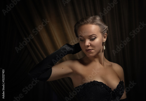 young beautiful woman in black with pearl earrings