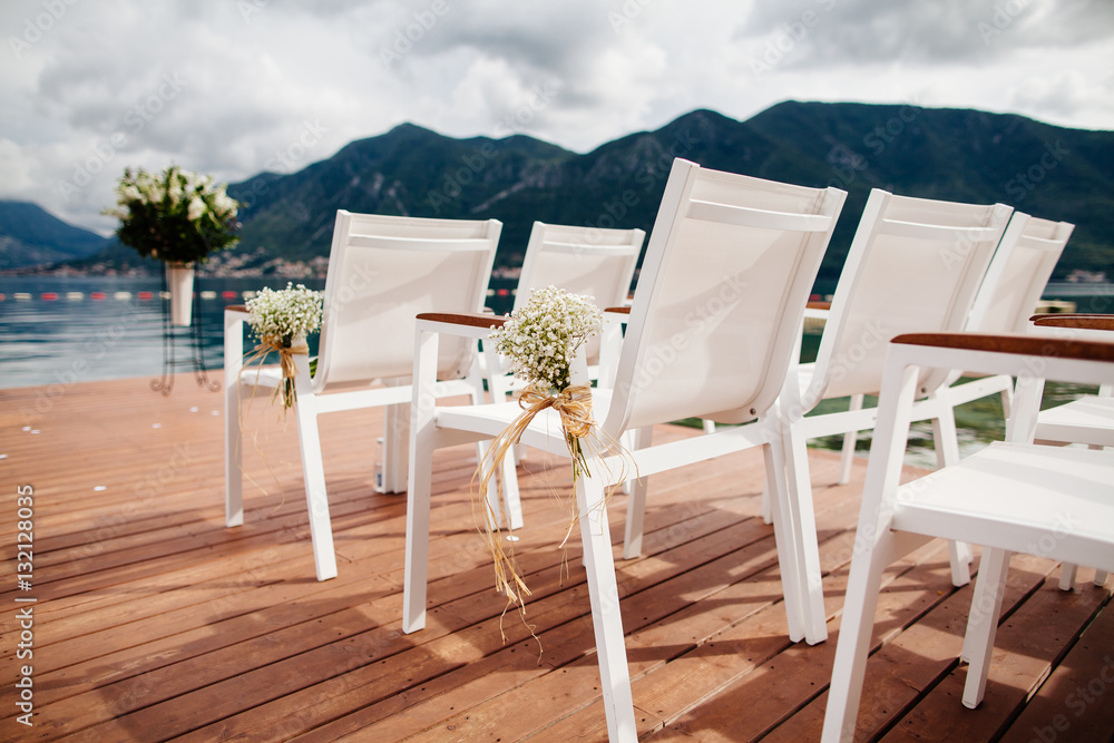 Fototapeta premium wedding chairs with flowers decoration