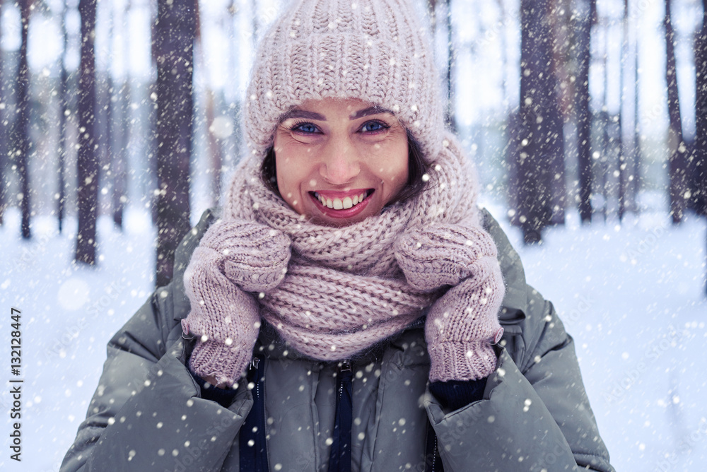 Charming lady observing snowfall in wintry forest Charming lady observing snowfall in wintry forest