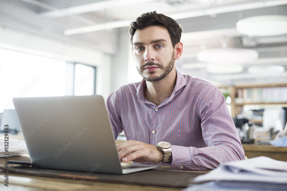 Male architect working with laptop in the office Male architect working with laptop in the office