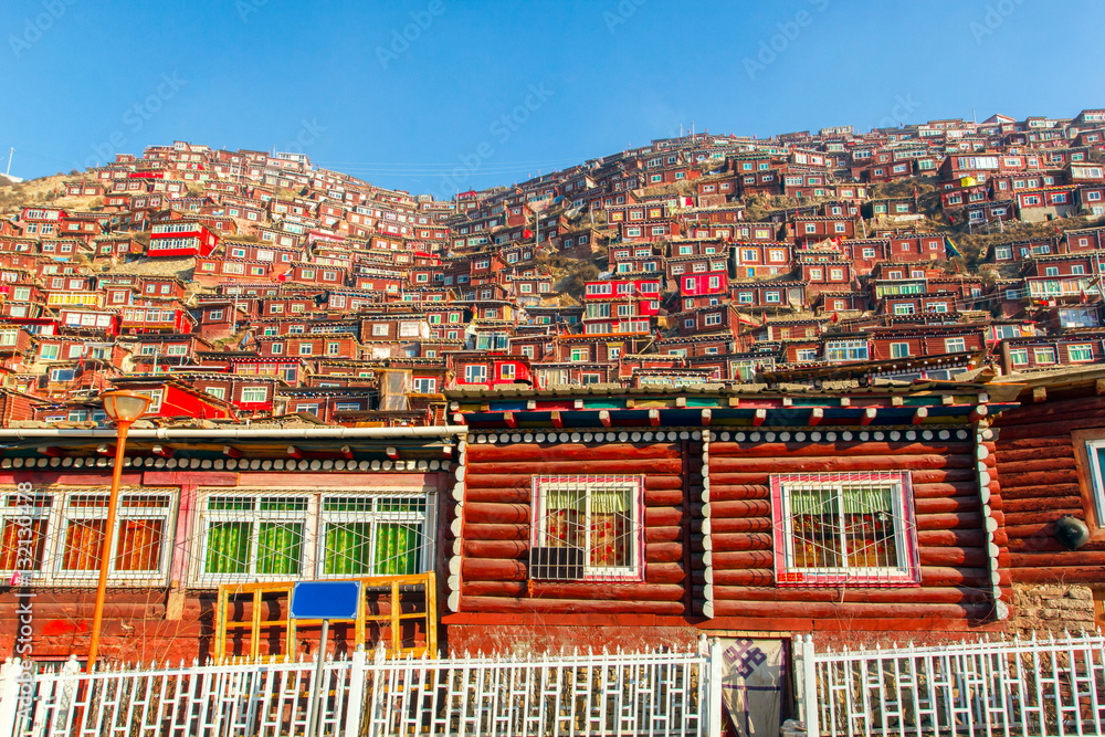 Red monastery and home at Larung gar (Buddhist Academy) in sunshine day and background is blue sky, Sichuan, China
