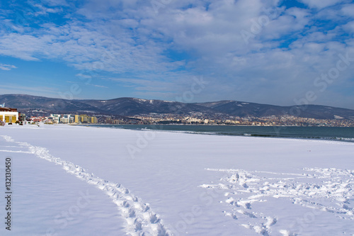 Fototapeta Naklejka Na Ścianę i Meble -  Snowy beach and sea at winter with blue sky