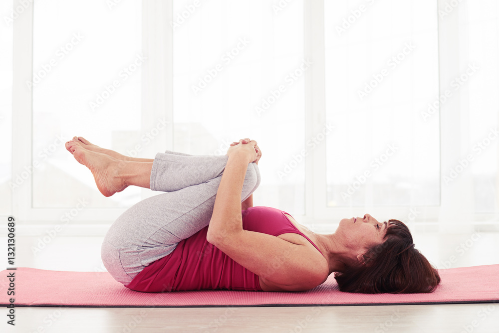 Relaxed woman having rest after performing exercises Relaxed woman having rest after performing exercises