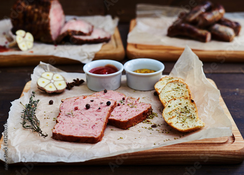 Tasty pieces of meat served with crusty bread, ketchup and frenc photo