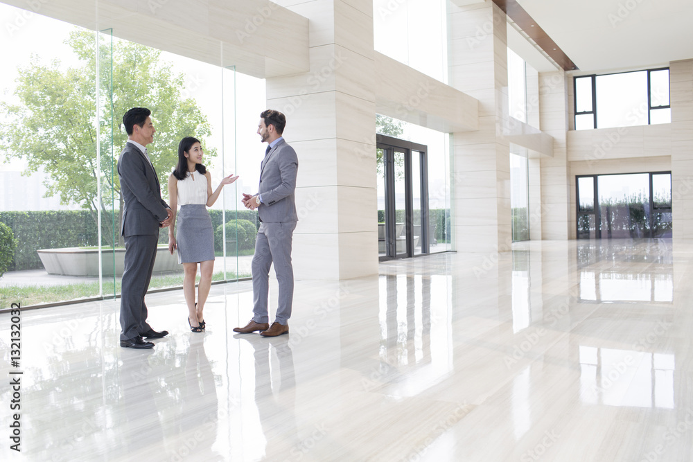 Business people talking in the office lobby Business people talking in the office lobby