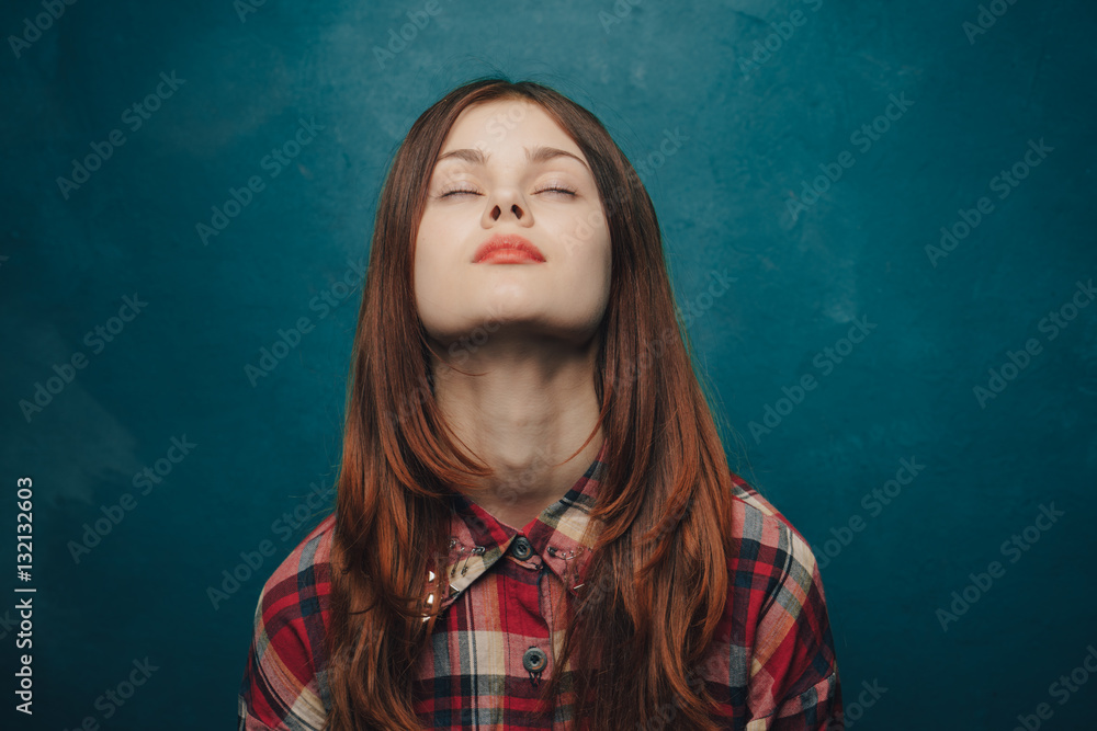 beautiful woman in a plaid shirt on a blue background beautiful woman in a plaid shirt on a blue background