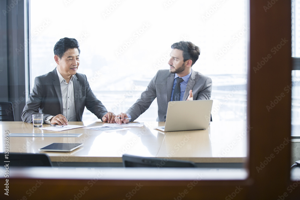 Business people discussing with each other in the meeting room Business people discussing with each other in the meeting room