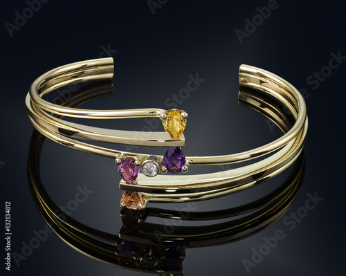 Fotografie golden bracelet isolated on black