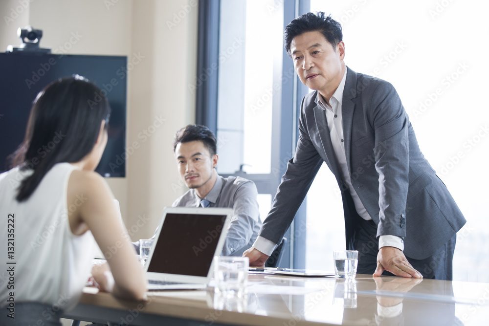 Business people talking in meeting room Business people talking in meeting room