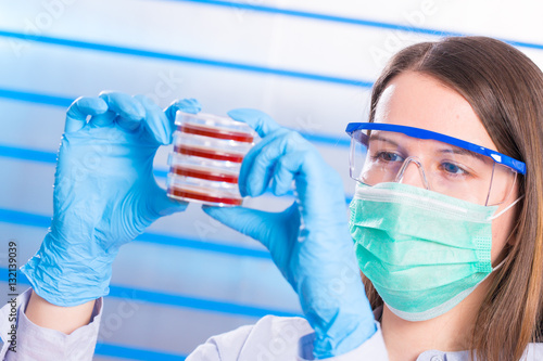 Young woman scienist in laboranory photo