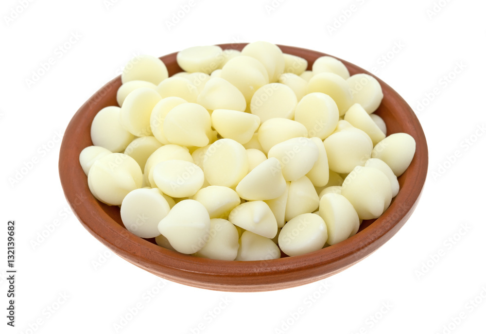 White chocolate baking chips in a small bowl isolated on a white background. White chocolate baking chips in a small bowl isolated on a white background.