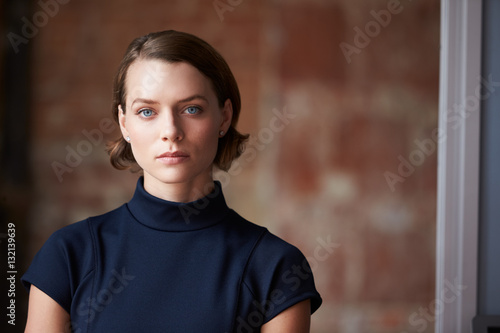 Head And Shoulders Portrait Of Young Businesswoman In Office photo