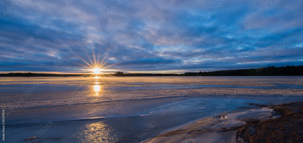 Scenic view of a lake in winter at sunset