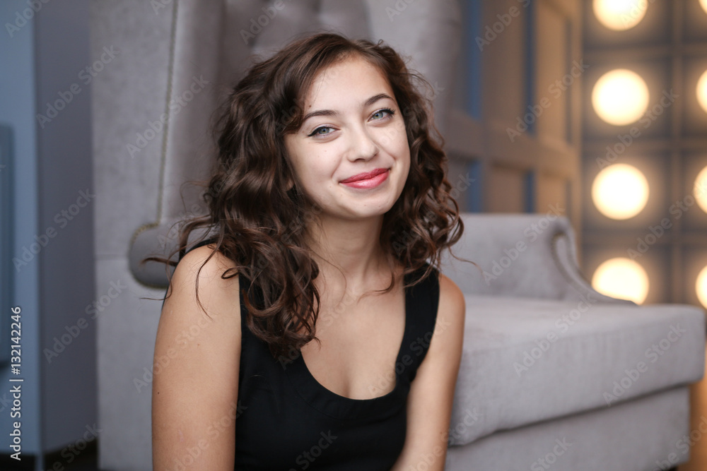 Portrait of beautiful girl in evening dress sitting on floor in luxury interiors Portrait of beautiful girl in evening dress sitting on floor in luxury interiors