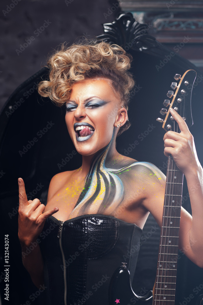 Impressed woman punk showing metal horns. Rocker girl in courage posing at  camera with her bass guitar, bright makeup and hairstyle. Subculture,  lifestyle, art, music, drive concept Stock Photo | Adobe Stock