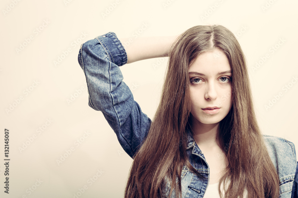 Portrait of the beautiful young girl with long brown hair in studio Portrait of the beautiful young girl with long brown hair in studio