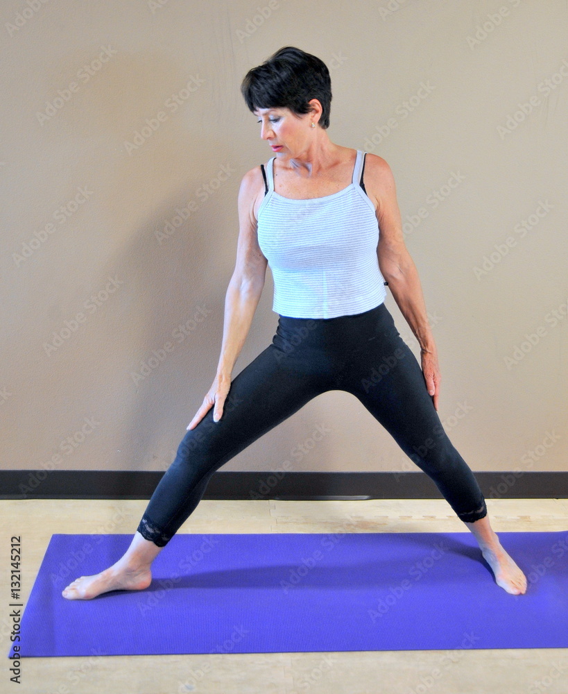 Mature female beauty doing her yoga exercises. Mature female beauty doing her yoga exercises.