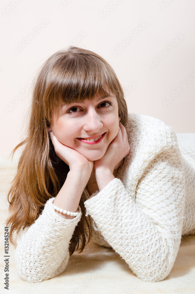 Young beautiful woman in warm knitted handmade clothes at home Young beautiful woman in warm knitted handmade clothes at home