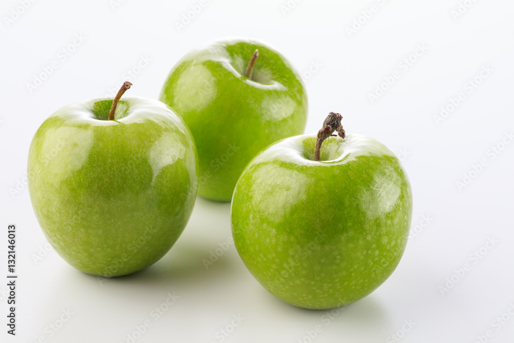 Three green apples on a white background with stem Three green apples on a white background with stem