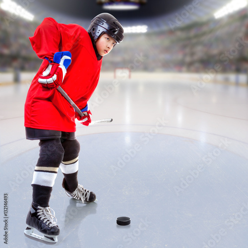 Photography Junior Ice Hockey Player Puck Handling in Arena With Copy Space.
