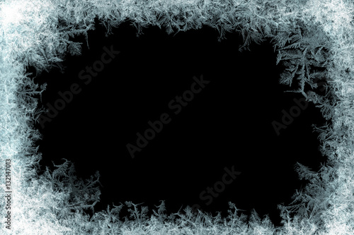 Frostwork. Decorative ice crystals frame on black matte background