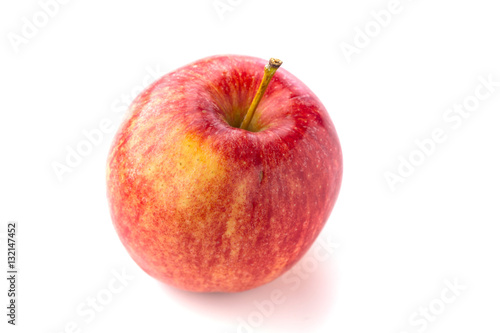 Shot from above of a ripe red juicy macintosh apple with a stem on a bright background