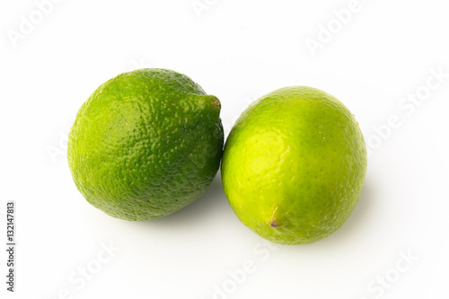 Fototapeta Naklejka Na Ścianę i Meble -  Closeup of two spotted bright green limes