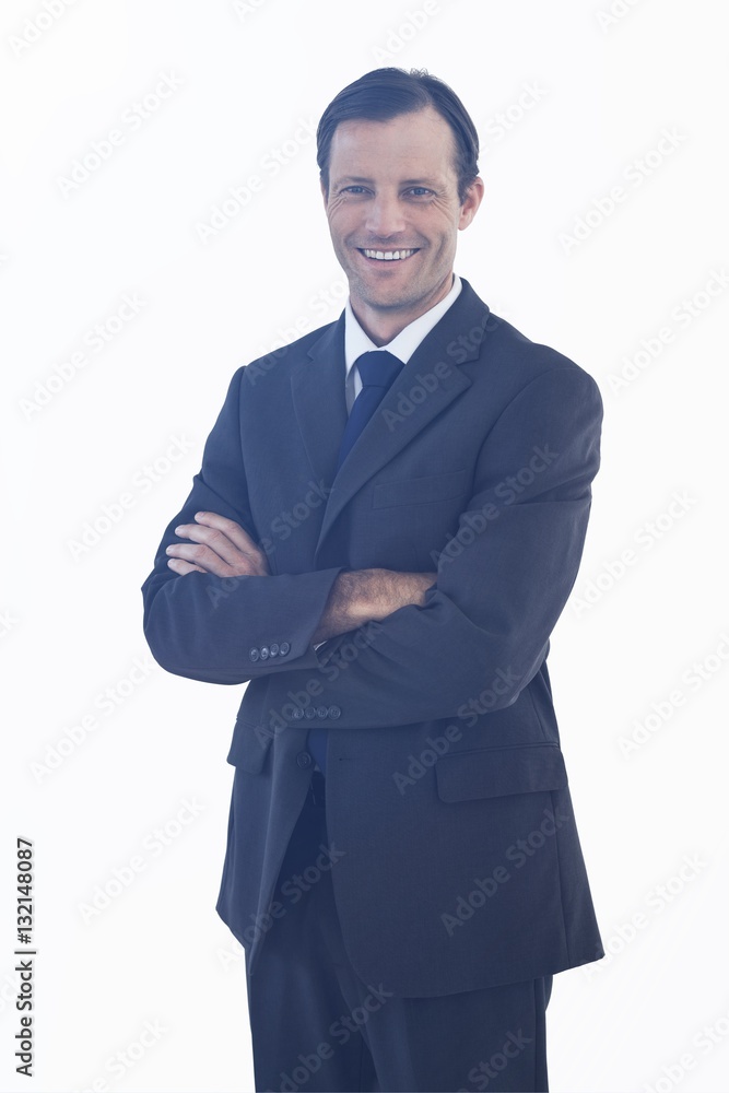 Charismatic smiling businessman standing with arms crossed Charismatic smiling businessman standing with arms crossed