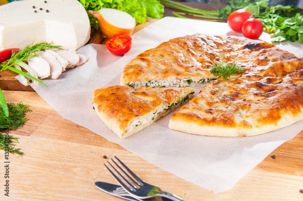 Selective Focus Traditional meat closed pie on the table. Composition of ingridients. Selective Focus Traditional meat closed pie on the table. Composition of ingridients.