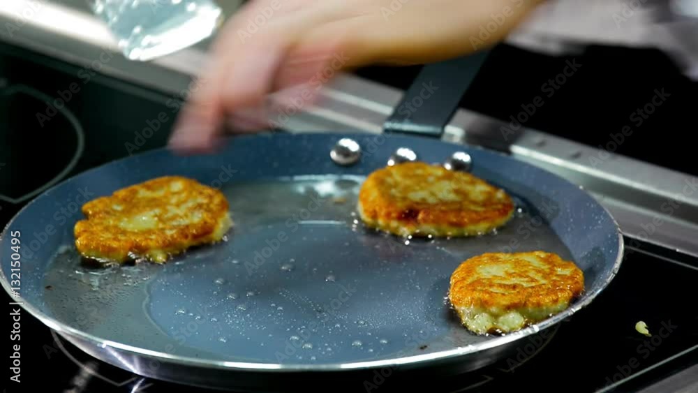 cooking potato pancakes in a frying pan. cooking potato pancakes in a frying pan.