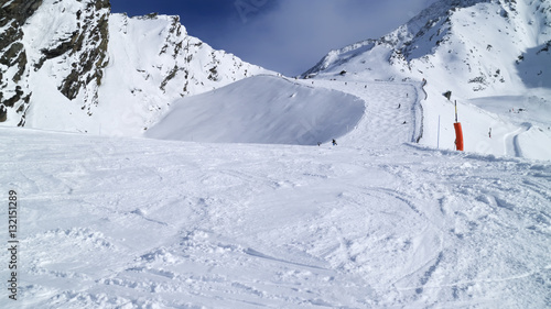 Snowy mogul slope on top of mountains, French Alps