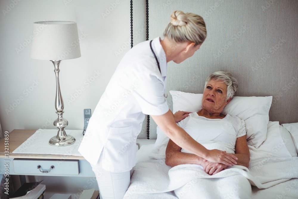 Female doctor interacting with senior patient Female doctor interacting with senior patient