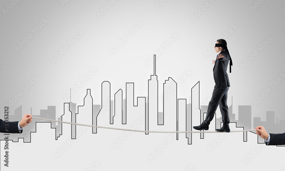 Business concept of risk support and assistance with man balancing on rope Business concept of risk support and assistance with man balancing on rope