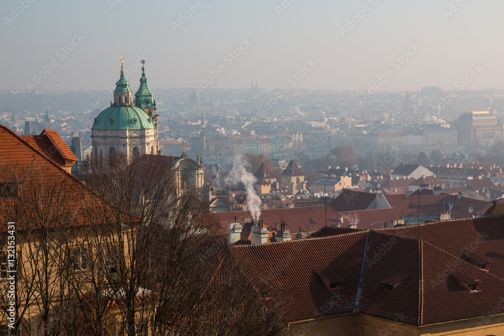 The red roof in Prague. Panoramic view of Prague in winter day with dense fog in the city.