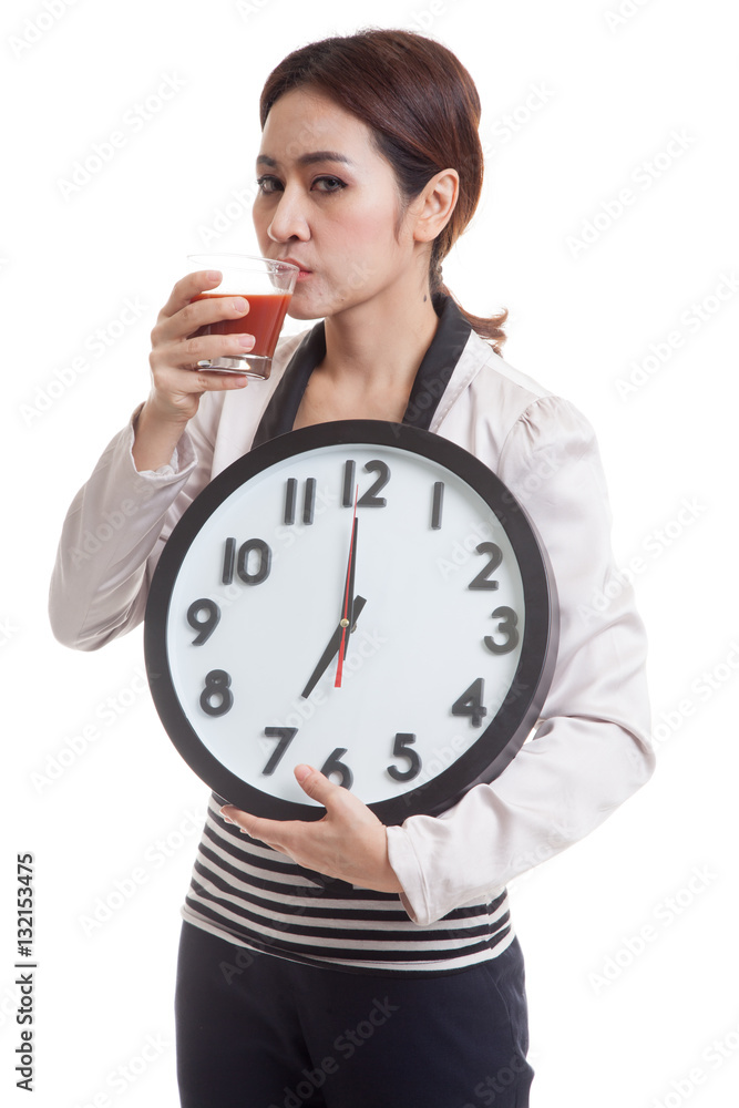 Young Asian business woman with tomato juice and clock. Young Asian business woman with tomato juice and clock.