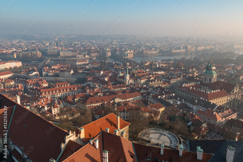 Obraz premium The red roof in Prague. Panoramic view of Prague in winter day with dense fog in the city.