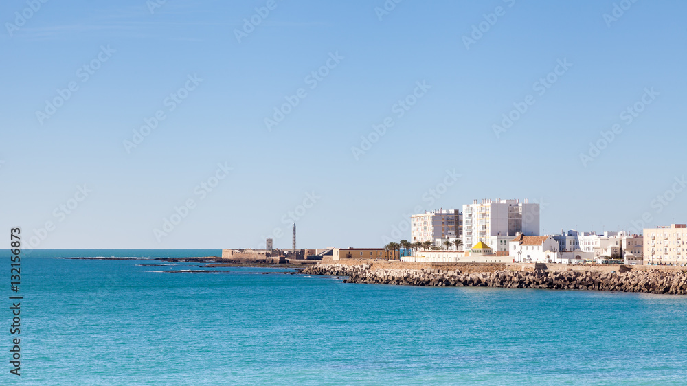 Cadiz Waterfront.  A view of the Cadiz waterfront in Spain with the Castillo de San Sebastian in the background.