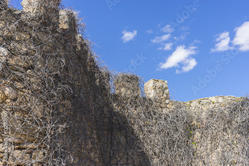 Stone walls of a medieval castle. Town of Consuegra in the provi
