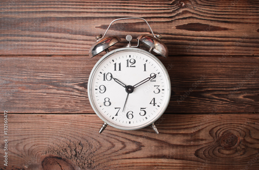 The alarm clock on the wooden surface. Good morning. Time To Get Up
The alarm clock on the wooden surface. Good morning. Time To Get Up