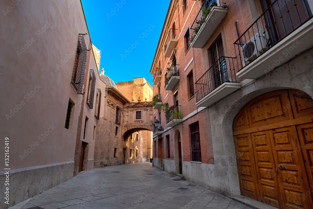 Fototapeta premium Valencia Spain Narrow Street with Arch Bridge