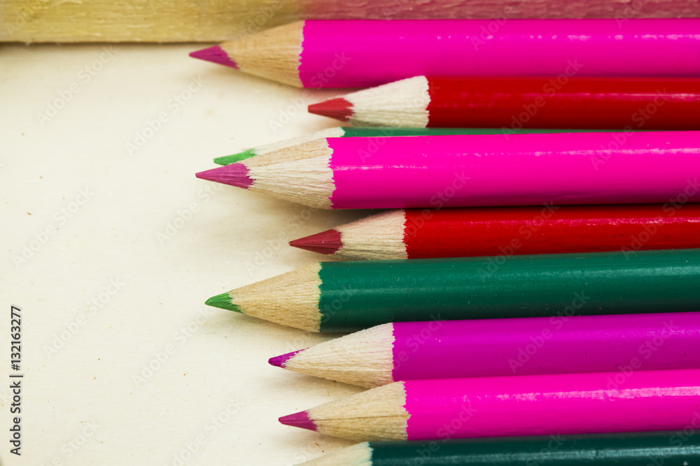 Group of sharp colored pencils with wooden background Group of sharp colored pencils with wooden background